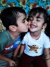 Boy kissing sister