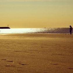 Scenic view of beach at sunset