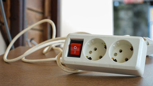 Close-up of telephone booth on table