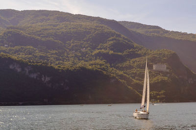 Sailboat by sea against sky