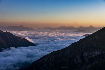 Scenic view of snowcapped mountains against sky during sunset