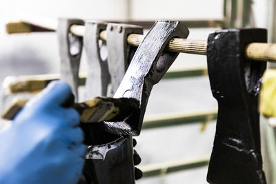 Close up on carpenter painting restored axes