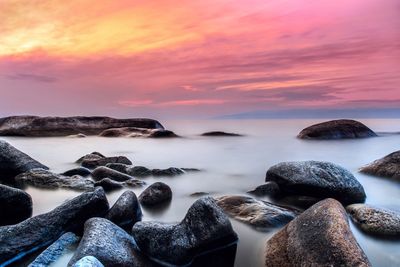 Scenic view of sea against sky at sunset