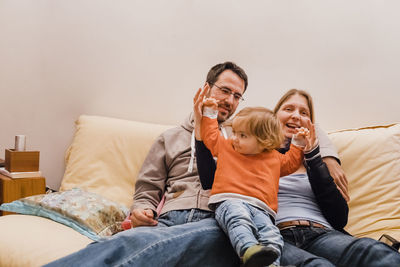 Family relaxing on sofa at home