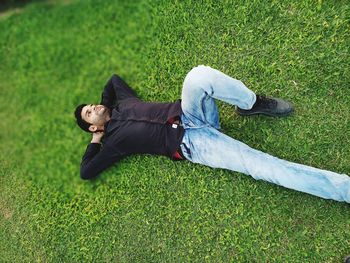 High angle view of man lying on field