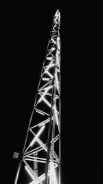 Illuminated ferris wheel against sky at night