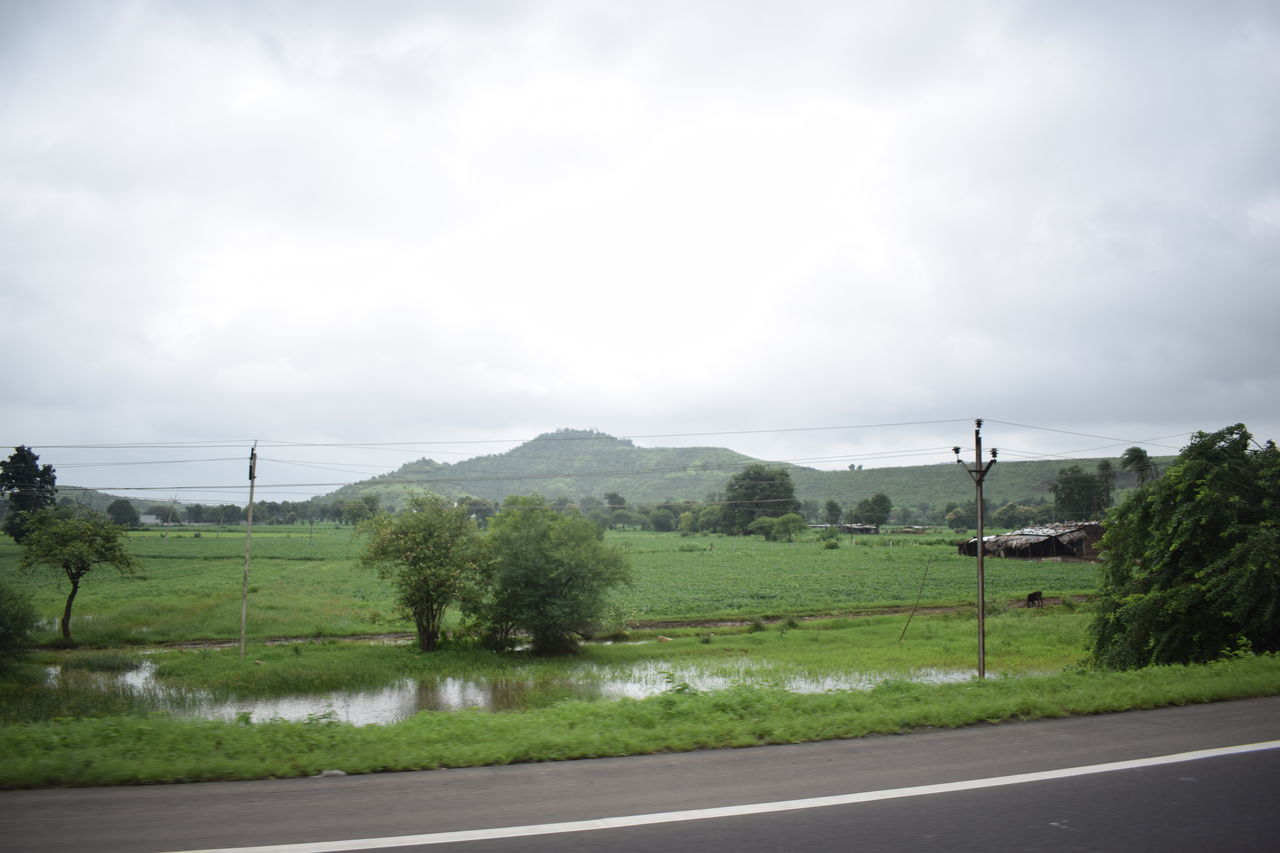 SCENIC VIEW OF ROAD BY LANDSCAPE AGAINST SKY