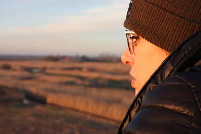 Portrait of man wearing hat against sky during sunset