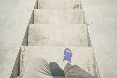 Low section of man standing on footpath