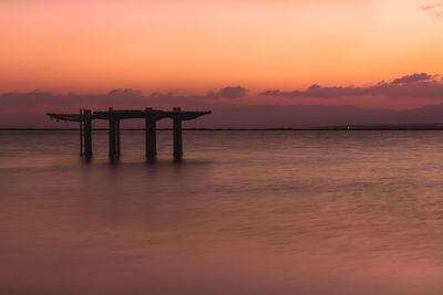 Silhouette pier on sea against sky during sunset