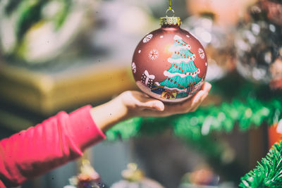 Close-up of hand holding christmas decoration