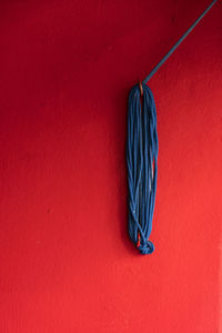 Blue coloured rope hanging on wall