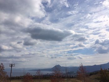 Scenic view of landscape against cloudy sky