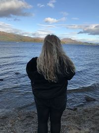 Rear view of woman standing on beach