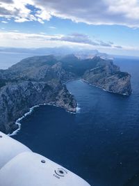 High angle view of sea and mountains against sky