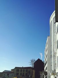 Low angle view of buildings against blue sky