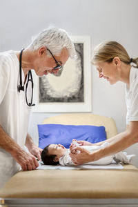 Doctors examining baby