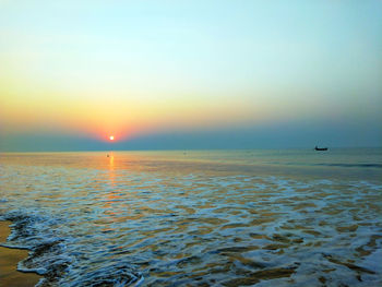 Scenic view of sea against clear sky during sunset