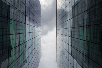 Low angle view of modern glass building against sky