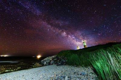 Scenic view of beach against star field