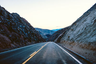 Country road leading towards mountains