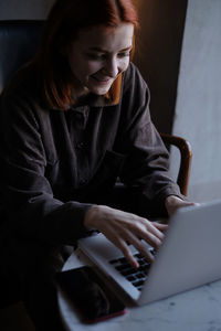 Portrait of smiling businesswoman working on laptop