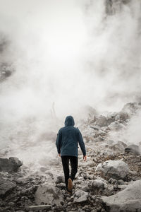 Rear view of man standing on mountain