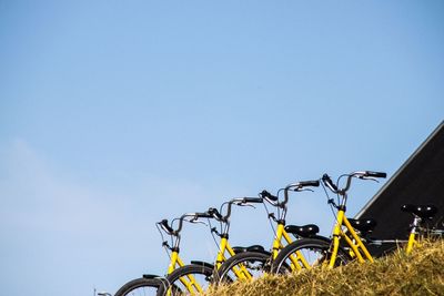 Low angle view of bicycle against clear blue sky