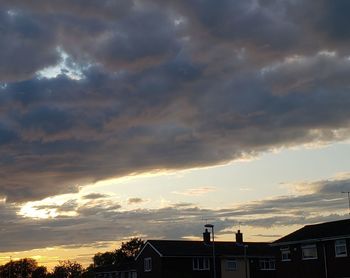 Silhouette buildings against sky during sunset