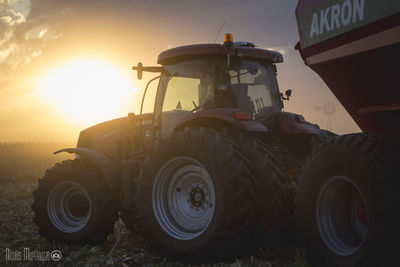 Old tractor on field against sky