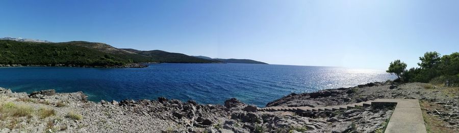 Scenic view of sea against clear blue sky