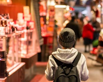 Rear view of boy looking at store