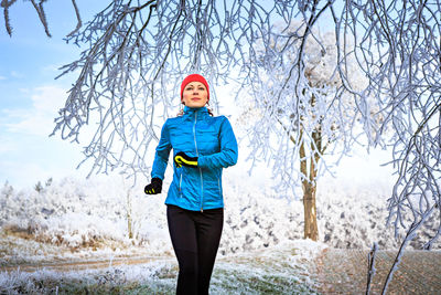 Woman running on field during winter