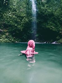 Rear view of woman in pink water