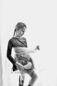 Young woman looking away against white background