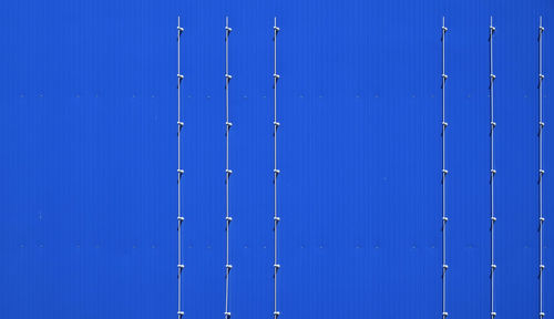 Close-up of poles against wall 