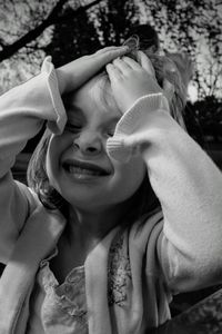 Close-up of girl with head in hands