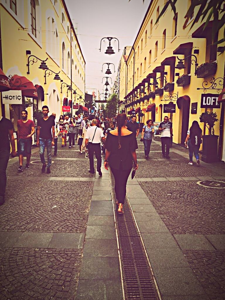 PEOPLE WALKING ON STREET IN CITY