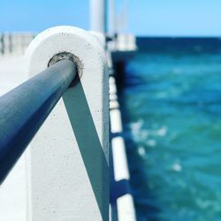 Close-up of railing by sea