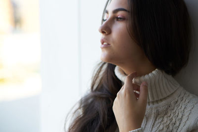 Close-up of young woman looking away