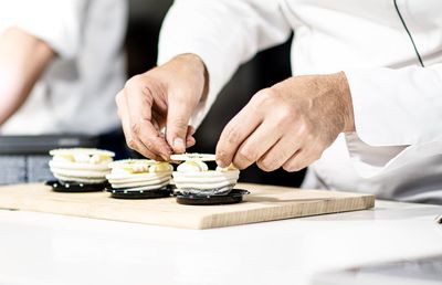 Midsection of man preparing food on table