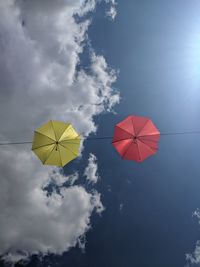 Low angle view of multi colored flag against sky