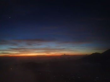 Scenic view of silhouette mountain against sky at sunset