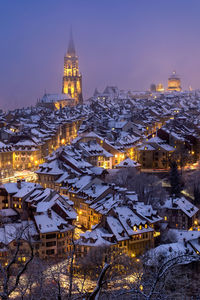 High angle view of illuminated buildings in city at night