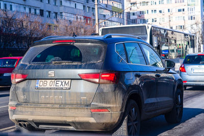 View of vehicles on road along buildings