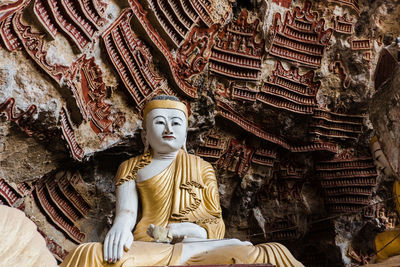 Statue of buddha against building