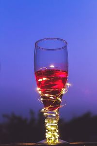 Close-up of wine glass against sky