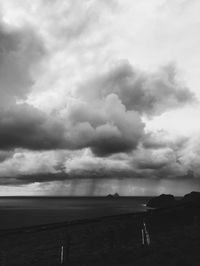 Scenic view of agricultural field against dramatic sky