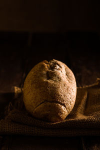 Close-up of bread on table against black background