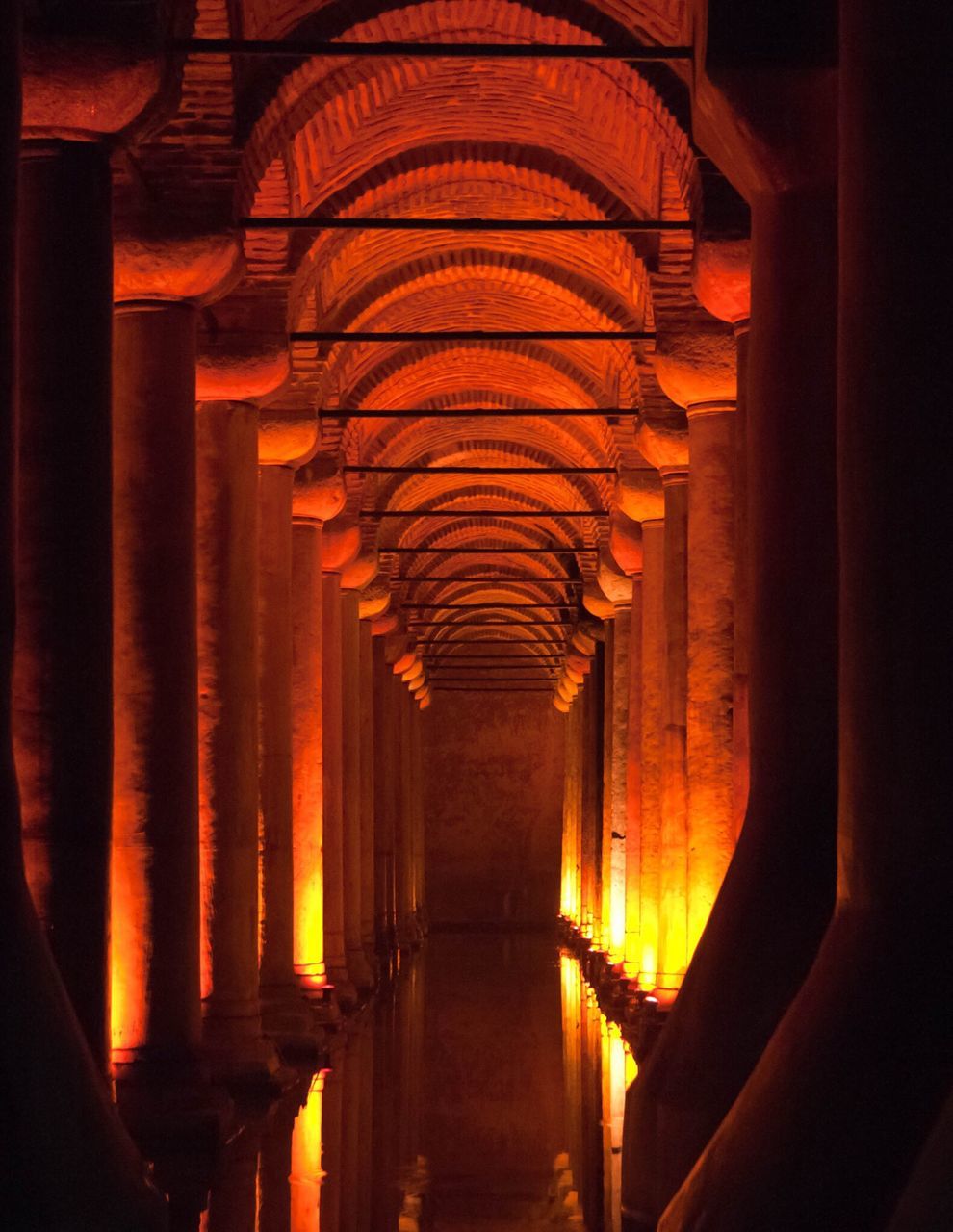 indoors, illuminated, in a row, auto post production filter, empty, diminishing perspective, architecture, ceiling, long, orange color, the way forward, corridor, arch, vanishing point, electric light, architectural column, lit, architectural feature, modern, no people